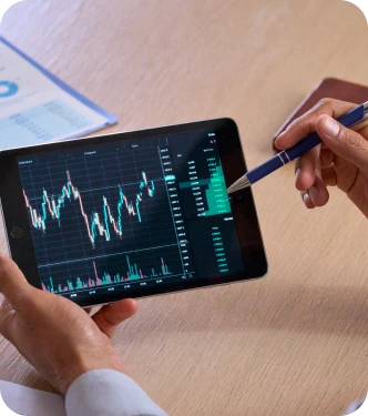 Conseiller analysant des graphiques boursiers sur tablette – TPE et PME avec excédents de trésorerie